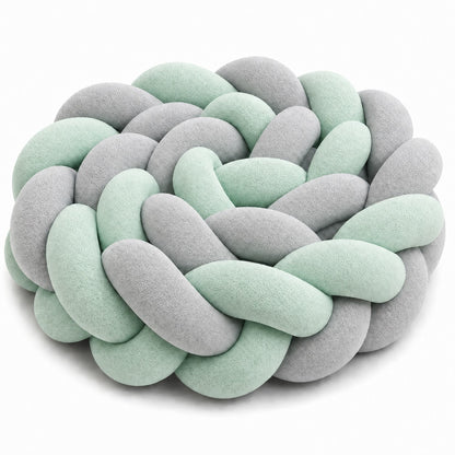 Tresse de lit bébé menthe et gris dans un berceau